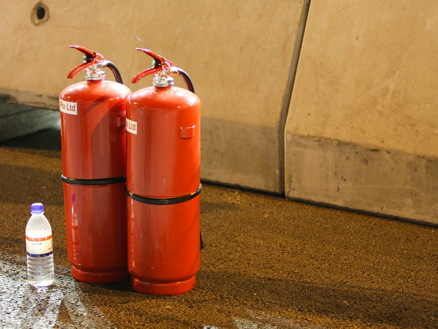 Pair of red fire extinguishers standing ready for use
