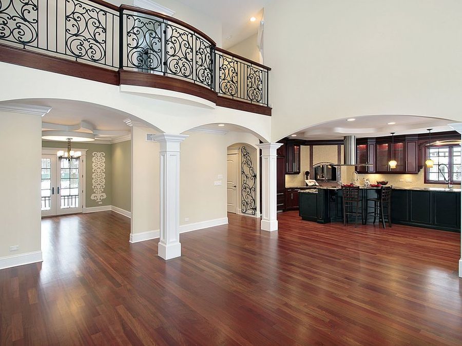 Bright open plan home with rich hardwood floors and arched doorways